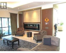 A living room with a brown sofa, a black coffee table, and a television.