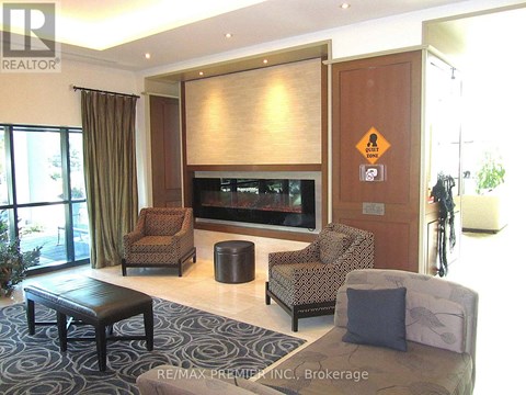A living room with a brown sofa, a black coffee table, and a television.