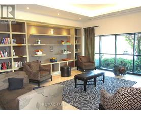 A living room with a couch, chair, and coffee table.