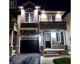 A house with a black front door and a red stop sign in front.