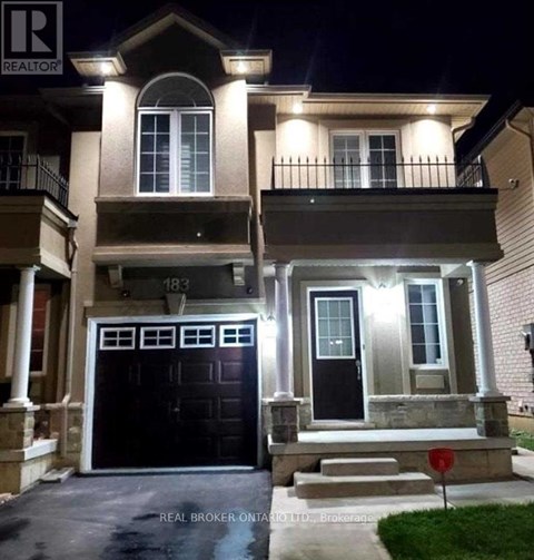 A house with a black front door and a red stop sign in front.