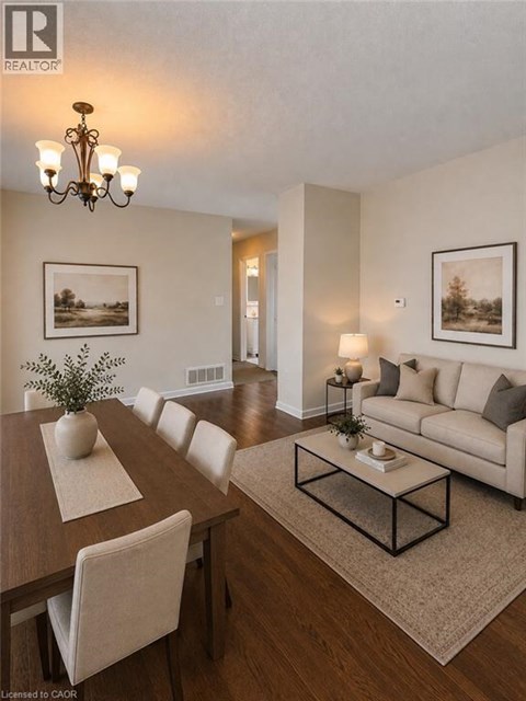 A well-lit living room with a dining table and a couch.
