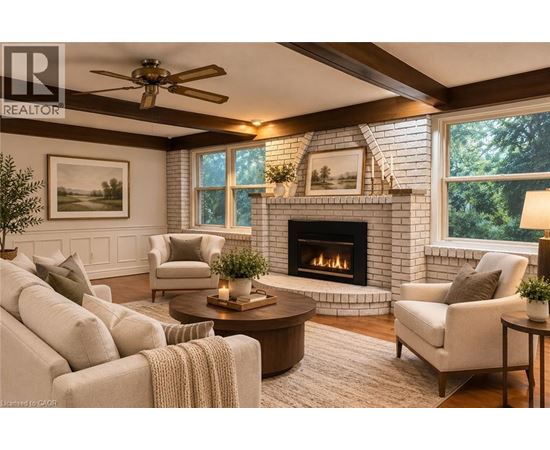 A living room with a fireplace and a ceiling fan.