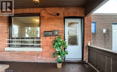 A house with a blue door and a sign that says REALTOR.