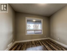 A room with a window and wooden floors.
