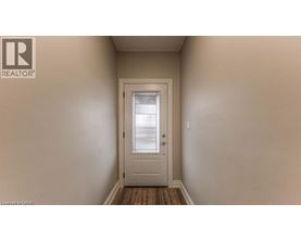 A white door is in the middle of a hallway.