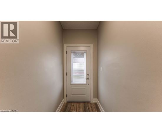 A white door is in the middle of a hallway.