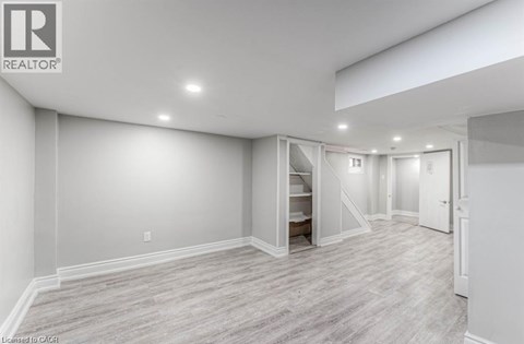 A spacious room with a staircase leading to the upper floor.