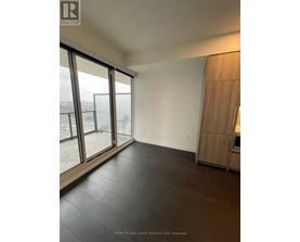 A spacious room with Prompton Real Estate Services Corp. logo on the wall.