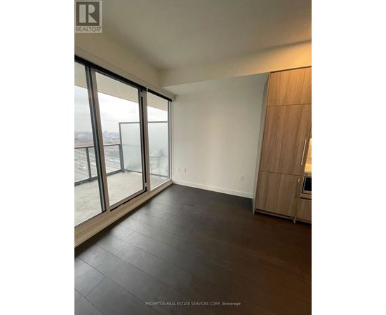 A spacious room with Prompton Real Estate Services Corp. logo on the wall.