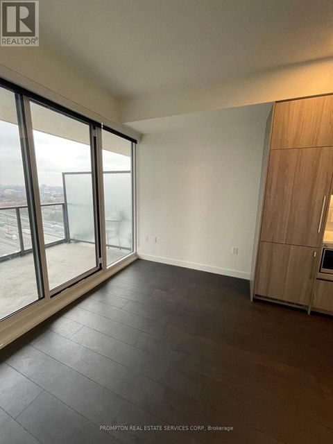 A spacious room with Prompton Real Estate Services Corp. logo on the wall.
