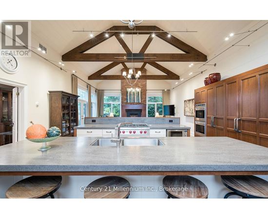 A kitchen with a large island and wooden cabinets.