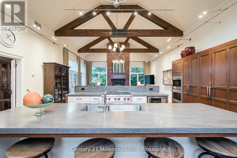 A kitchen with a large island and wooden cabinets.