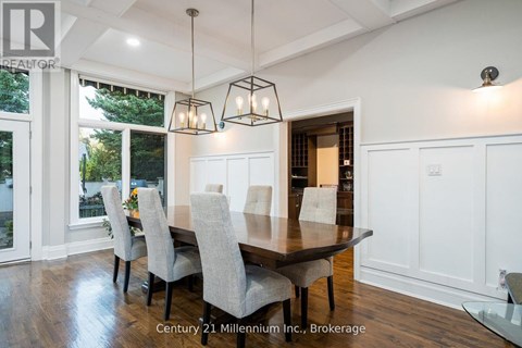 A dining room with a table and chairs.