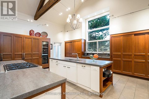 A kitchen with wooden cabinets and a large island.