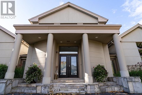 A house with a sign that says Century 21 Millennium Inc. Brokerage.