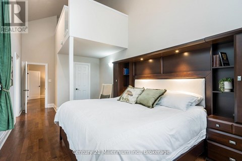 A bedroom with a large bed and a wooden headboard.