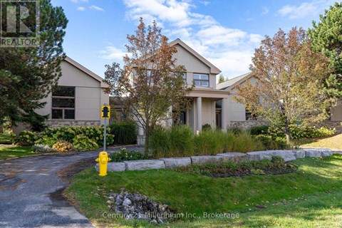A house with a yellow fire hydrant in front of it.