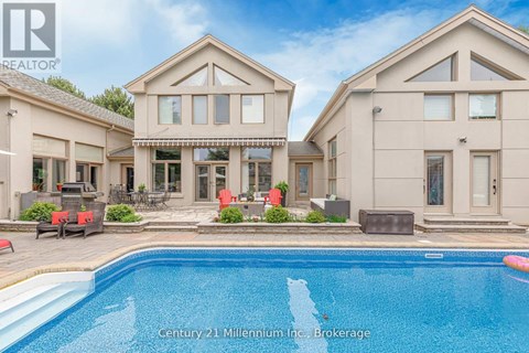 A large house with a pool in front of it.