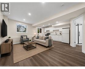 A living room with a grey couch, a coffee table, and a television.