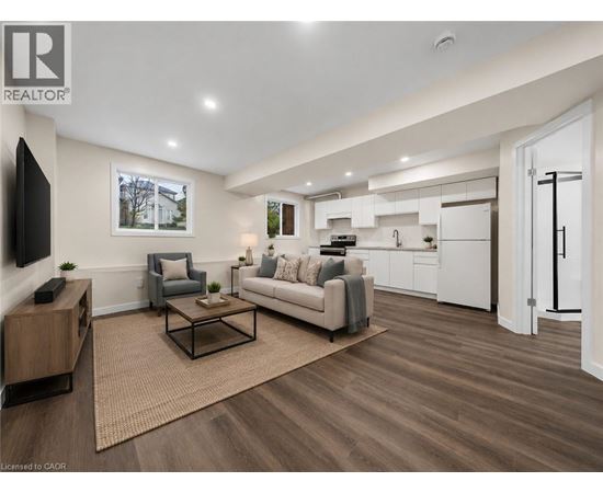 A living room with a grey couch, a coffee table, and a television.