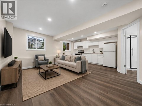 A living room with a grey couch, a coffee table, and a television.