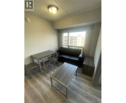 A living room with a couch, table, and chairs.