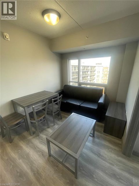 A living room with a couch, table, and chairs.