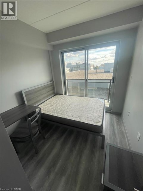 A bedroom with a bed, desk, and chair.