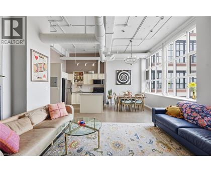 A living room with a couch, a coffee table, and a rug.