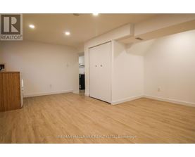 A room with a wooden floor and a white door.
