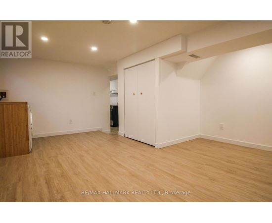 A room with a wooden floor and a white door.