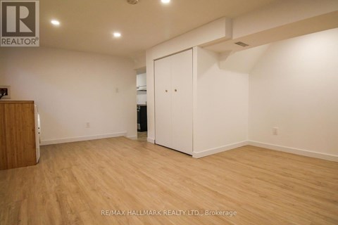 A room with a wooden floor and a white door.