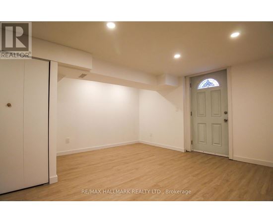 A room with a white door and a window with a stained glass design.