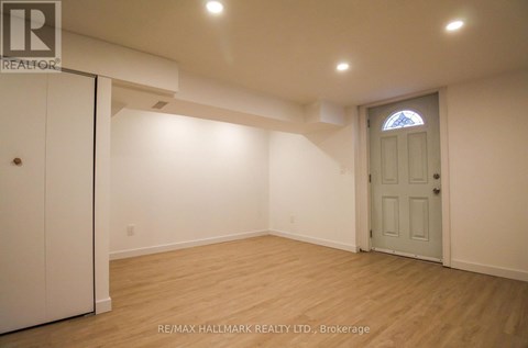 A room with a white door and a window with a stained glass design.