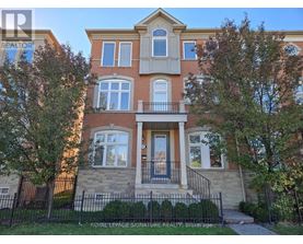 A two-story brick house with a balcony in front.