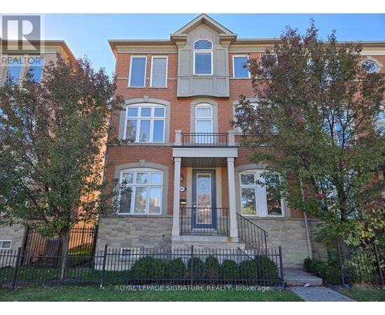 A two-story brick house with a balcony in front.
