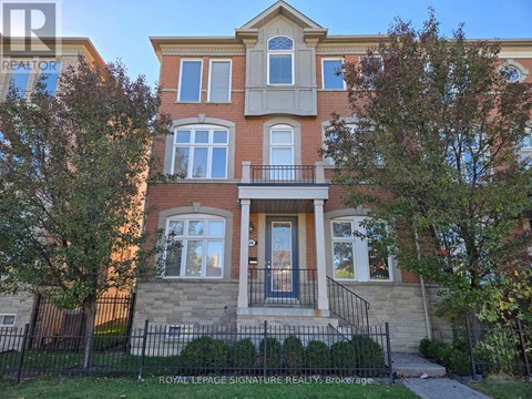 A two-story brick house with a balcony in front.