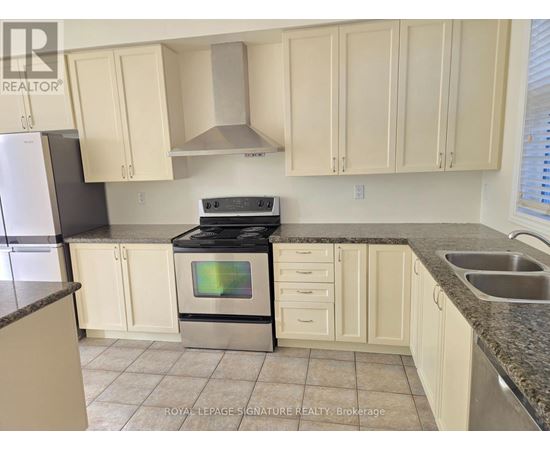 A kitchen with white cabinets and a black stove top oven.