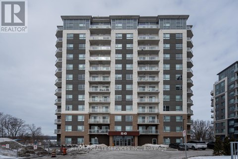 A large apartment building with the number 56 on the front.