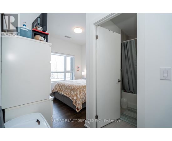 A bedroom with a bed, a toilet, and a wardrobe.