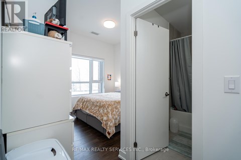 A bedroom with a bed, a toilet, and a wardrobe.