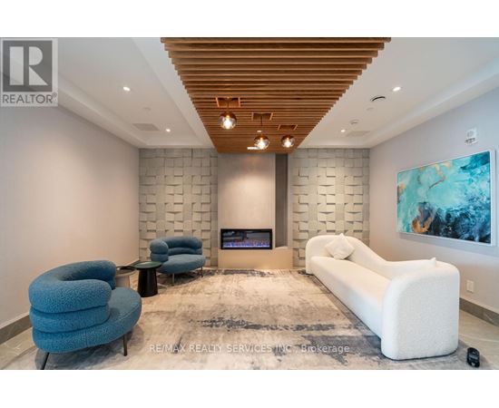A modern living room with a fireplace and a large painting on the wall.