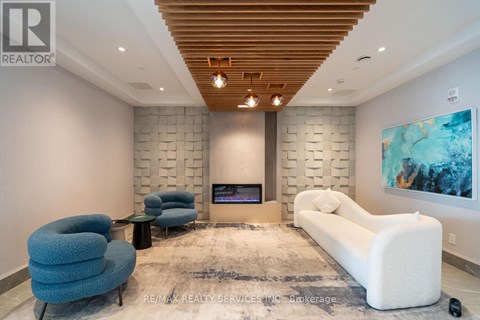 A modern living room with a fireplace and a large painting on the wall.