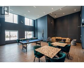 A room with a pool table, chairs, and a dining table.