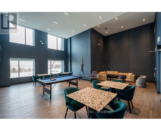 A room with a pool table, chairs, and a dining table.