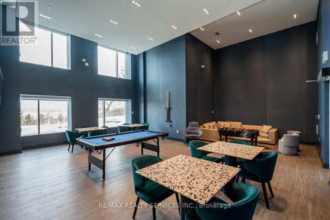 A room with a pool table, chairs, and a dining table.