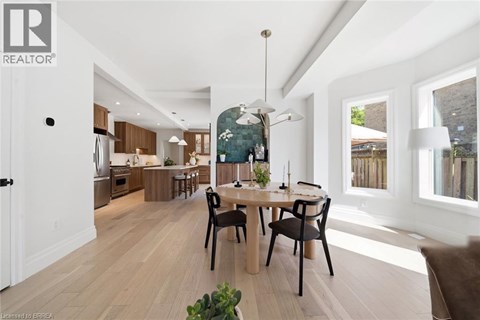 A modern dining room with a wooden table and chairs.