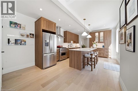 A modern kitchen with wooden cabinets and stainless steel appliances.