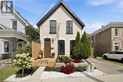 A house with a well-maintained garden in front.